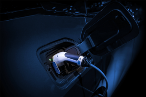 Economy 7: The image shows an electric or hybrid car being charged in the dark, presumably at night