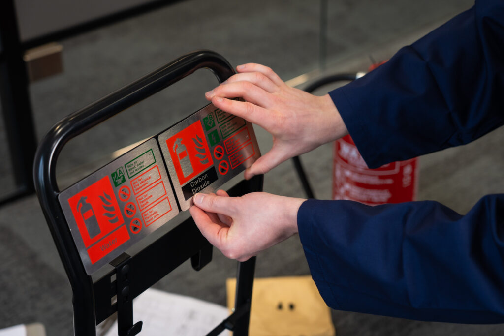 Firechief® flat-pack fire extinguisher stand comes with magnetic strips for extinguisher identification signs